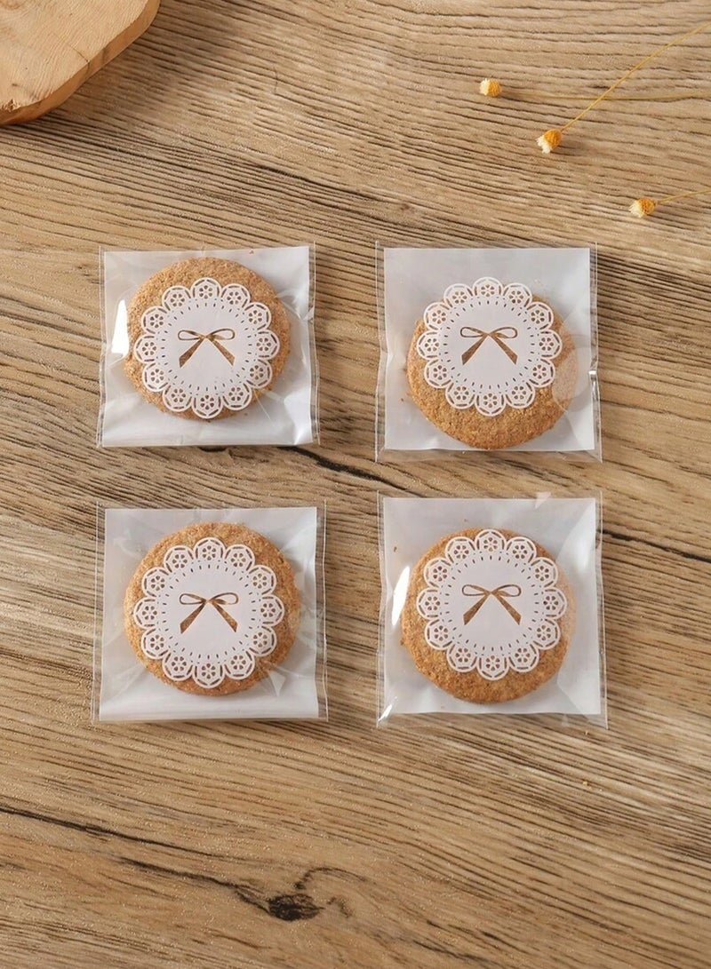 كوكنا أكياس تغليف حلويات، ذاتية اللصق بنمط فيونكة بيضاء، أكياس هدايا شفافة لعيد مبارك، أكياس صغيرة للبسكويت والشوكولاتة، 7x10 سم، 100 قطعة - Image 3